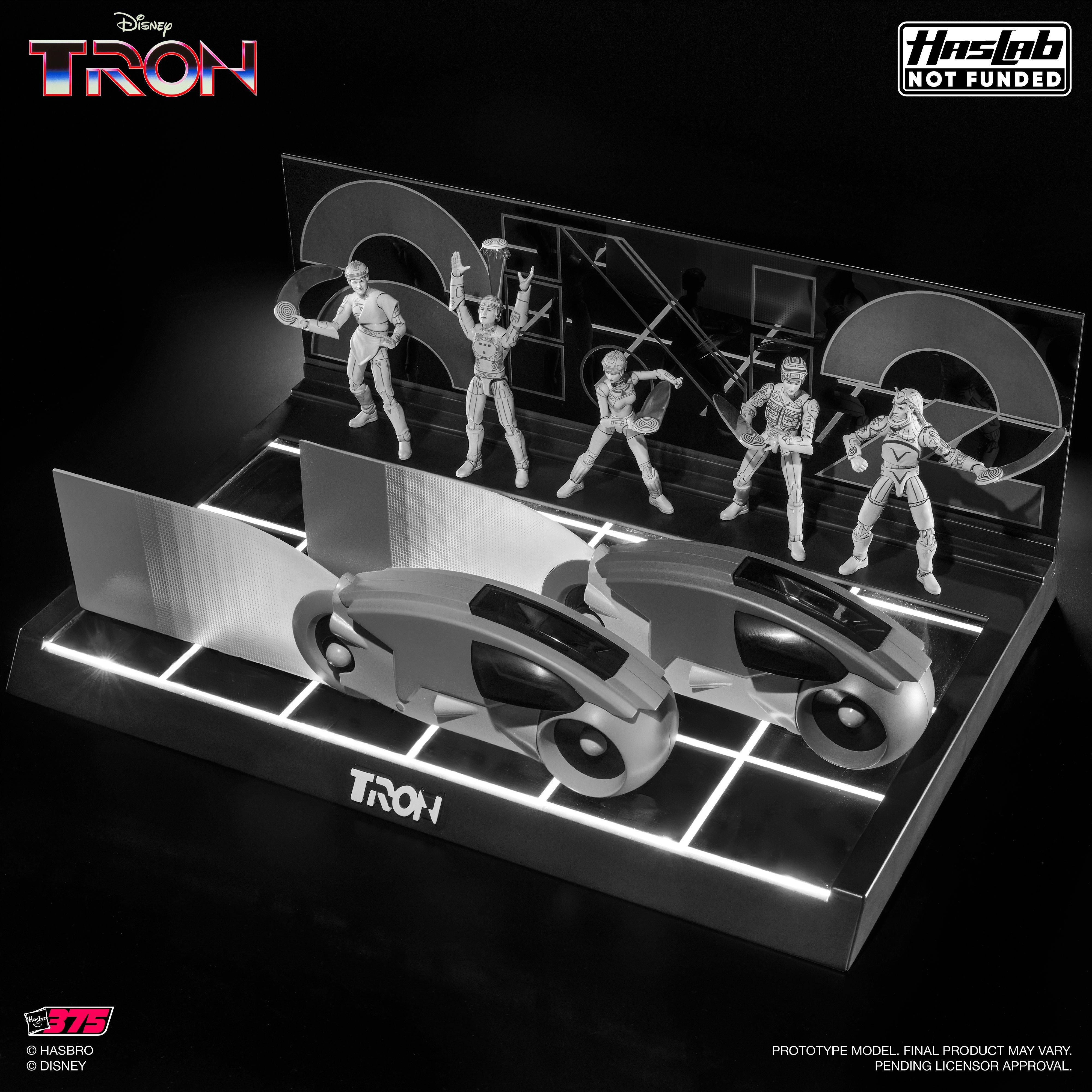 tam2shino's tweet card. Tron: Heroes of the Grid 3.75-inch set features Flynn, Tron, Yori, Sark, and 2 Light Cycles with detailed, retro design and a light-up Grid base.