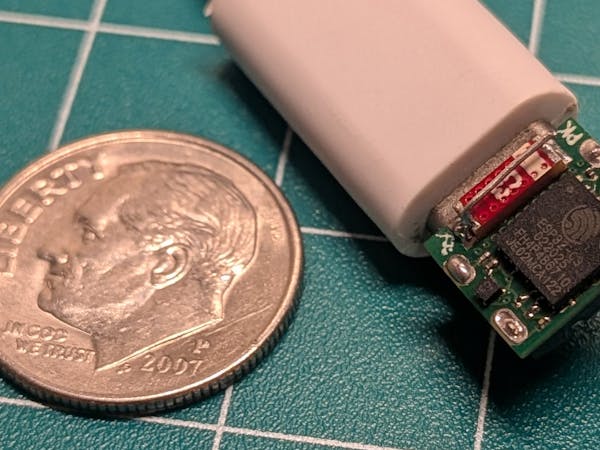 Hacksterio's tweet card. This incredibly tiny ESP32-C3 development board fits on the back of a USB-C connector to host web apps or control simple circuits.