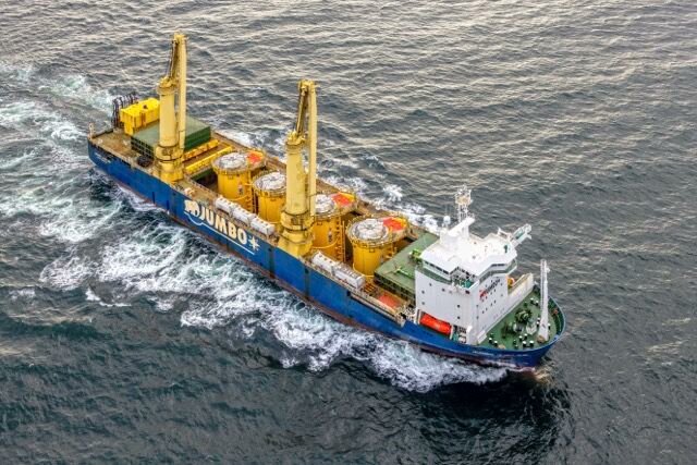 news_hmt70104's tweet card. The HLV Jumbo Jubilee is transporting 478-tonne Transition Pieces between Avilés and Rønne as part of a five-shipment program managed through the JSI Alliance. The voyage included a Rotterdam stop…