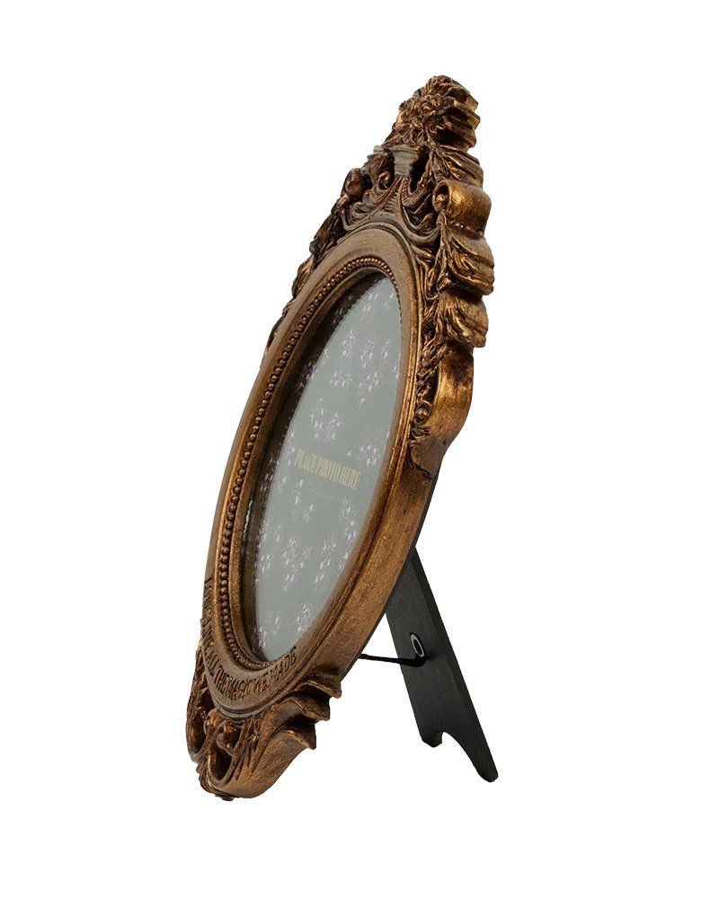 AlertsForMerch's tweet card. Brass oval antique style frame featuring "Long Live All The Magic We Made" song lyrics engraved on frame with floral design and "Place photo here" and "Taylor Swift" printed on paper inside frame....