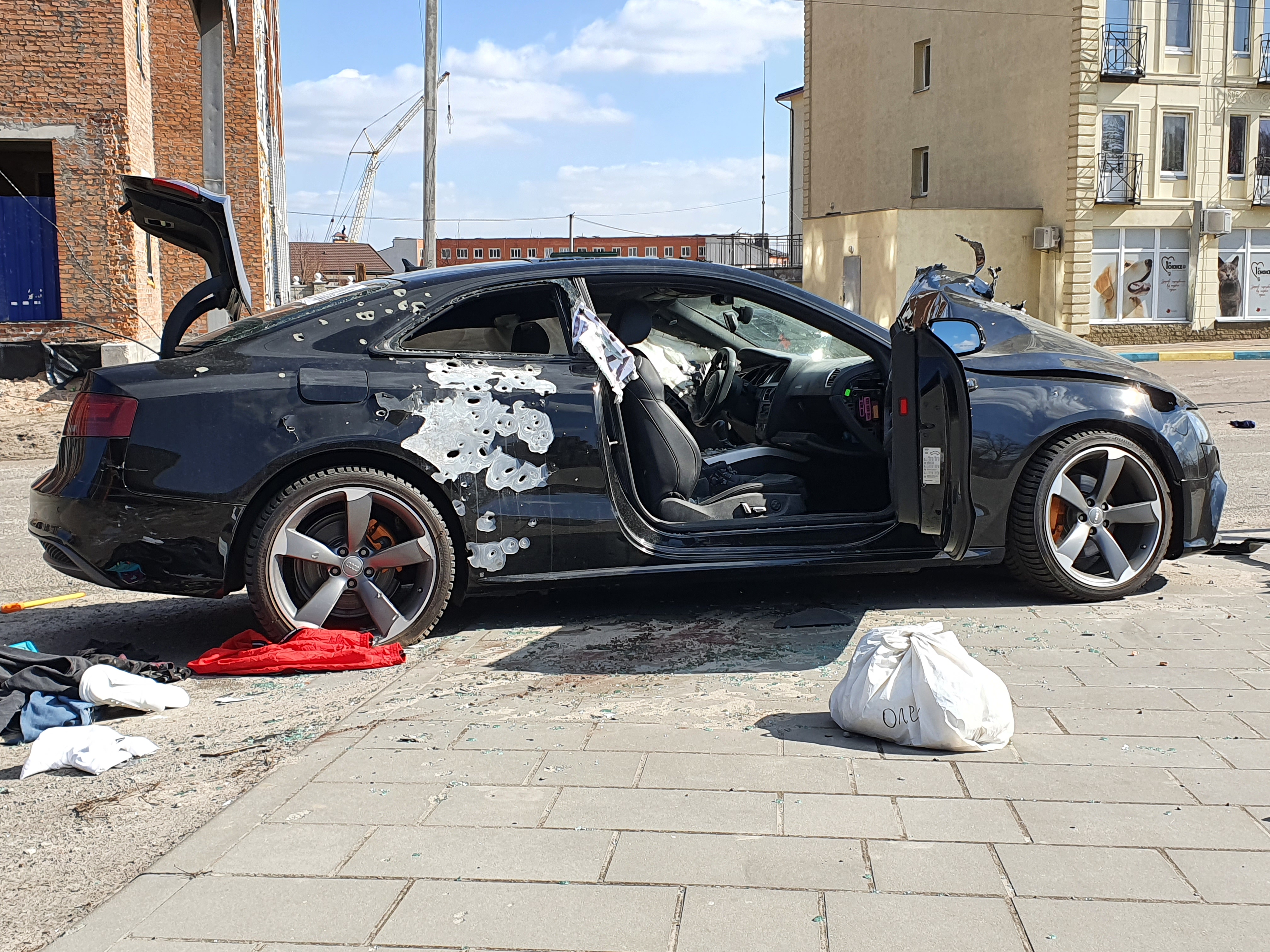 IgorKossov's tweet card. STOYANKA-2, Kyiv Oblast – In the village of Stoyanka-2 outside Kyiv, a half-dozen cars line the road, riddled with holes, their bodywork mangled by bullets and an explosion. Their windows, bearing...