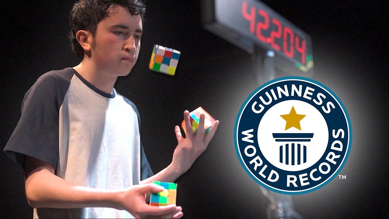 pdaveyelec's tweet card. Solving Three Puzzle Cubes WHILST JUGGLING - Guinness World Records