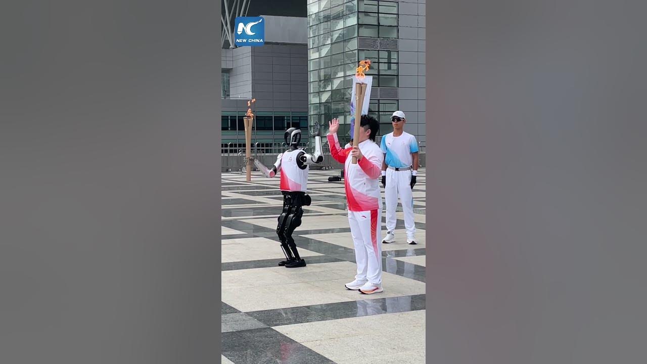 bamitav's tweet card. Humanoid robot in torch relay for China's National Games