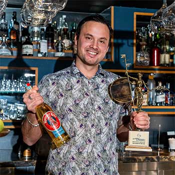 spiritsbusiness's tweet card. Amber Beverage Group has named the IBA's World Bartender of the Year winner Andrew Watson as its brand champion for Rooster Rojo Tequila.
