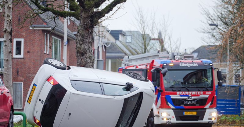 Auto belandt op zijkant na aanrijding met boom