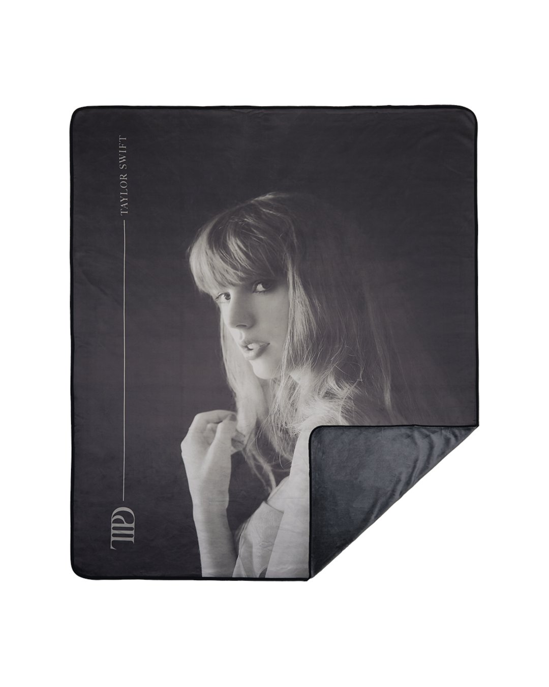 AlertsForMerch's tweet card. Dark gray fleece blanket featuring photo of Taylor Swift with "TTPD" and "Taylor Swift" with line design printed on front.100% polyester60" x 80"Limit 1 per order.Machine wash separately in cold...
