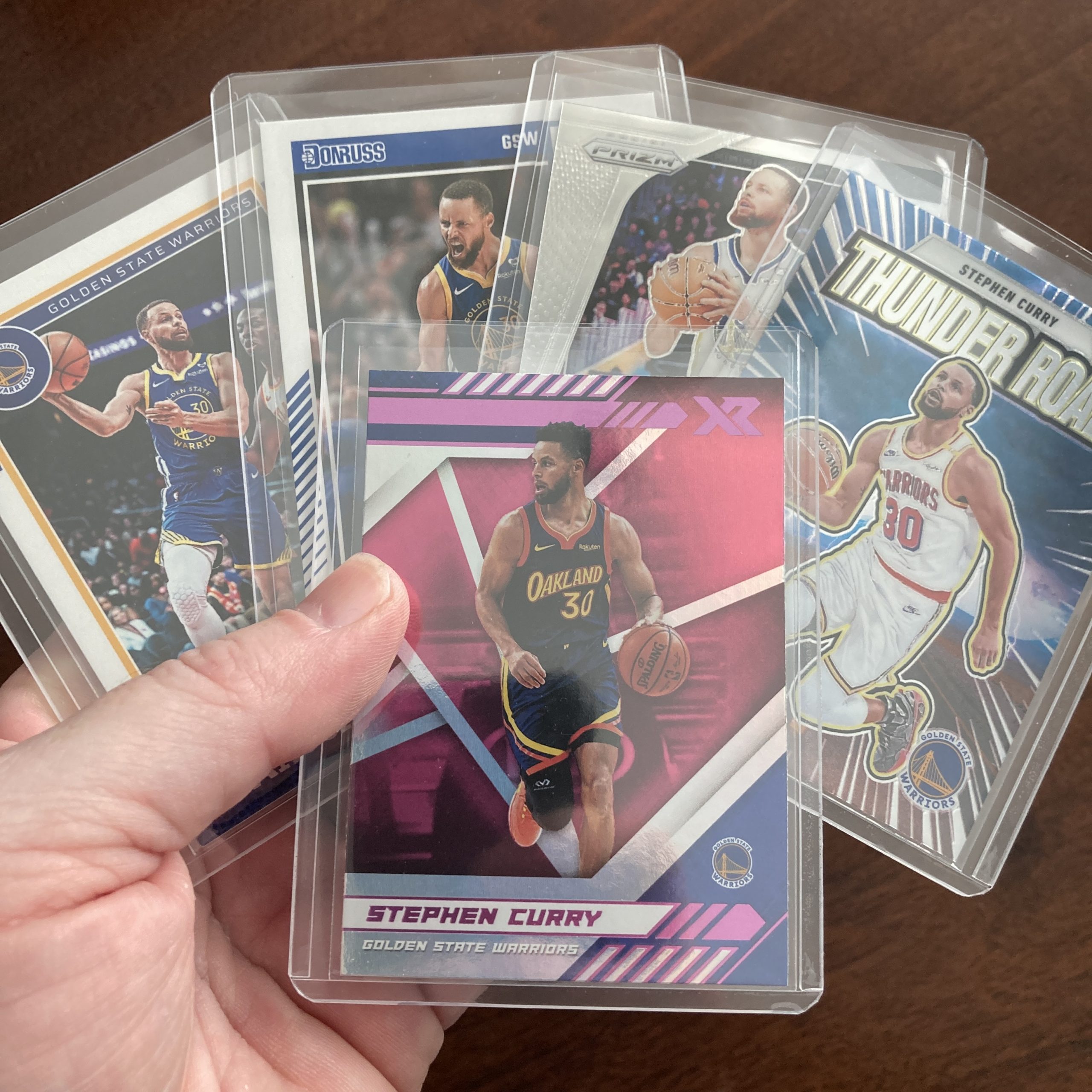 SlamSportsCards's tweet card. Curated pack of five different Stephen Curry basketball cards including a Panini Chronicles Xr SP Pink holofoil parallel card with other base and insert cards. Nice instant collection bundle of car…
