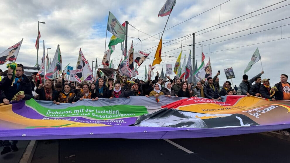 CommuneInt's tweet card. Kurds and their supporters from various European countries and many German cities arrived early in the morning at the Deutzer Werft area, where they unfurled giant posters of Abdullah Öcalan and lo...