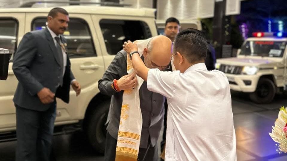 IndiaTodayNE's tweet card. Union Home Minister Amit Shah visits Siliguri, welcomed by Chief Minister Prem Singh Tamang. The visit aims to discuss development projects and strengthen state-centre ties.