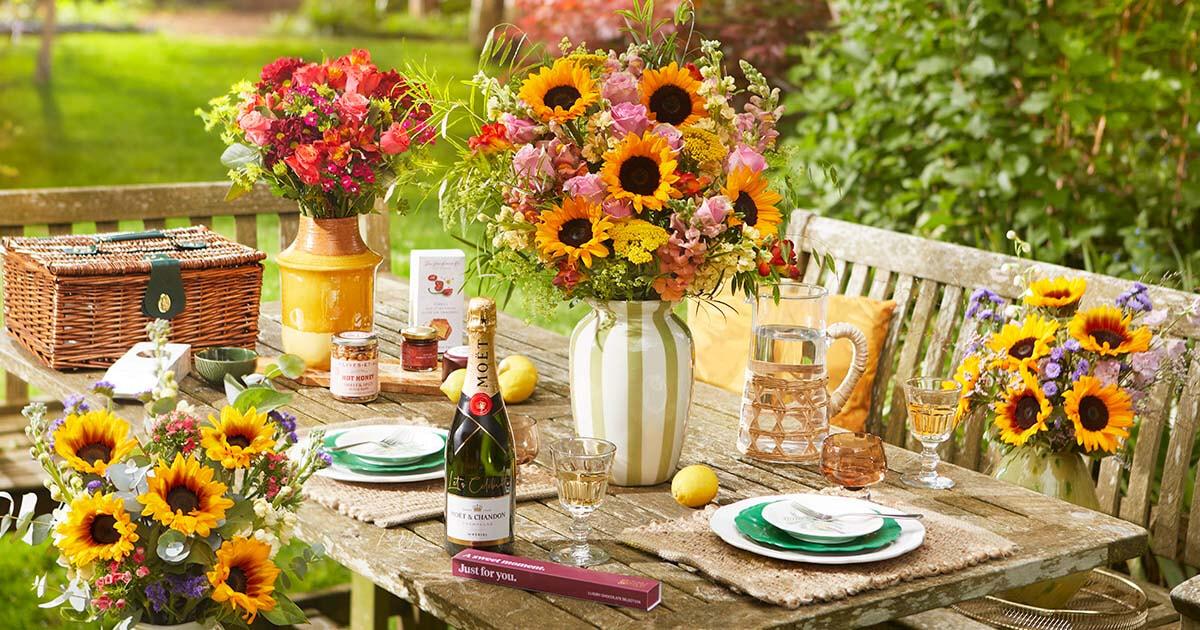 boxnipUK's tweet card. At Bloom & Wild, we don't just send flowers and gifts. We help you care wildly. And using this link, you can get £10 off your first shop with us.