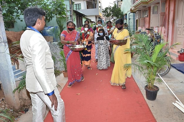 bhadript's tweet card. TUMAKURU: Event manager and Superstar Rajinikanth fan Ramachandra Rao made a huge splash in his neighbourhood by giving a grand red carpet welcome to his wife K