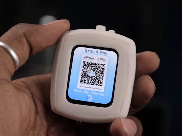 Hacksterio's tweet card. Sachin Soni turned a Makerfabs ESP32-S3 AMOLED display module into a wearable UPI payment device — just scan the QR code to split lunch.