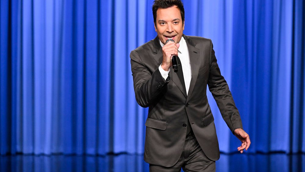 Phil_Lewis_'s tweet card. Jimmy Fallon says he plans to "keep my head down" and avoid politics on "The Tonight Show."