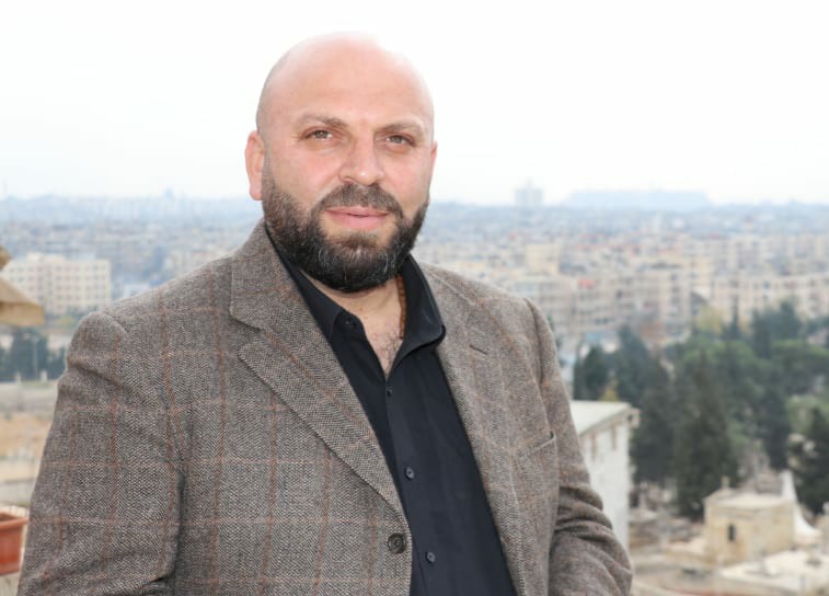 PYD_Rojava's tweet card. محمد أمين -- - خيارات المنطقة بين الديمقراطية أو الانهيار - تشهد المنطقة اليوم، من تركيا حتى سوريا بعد سقوط