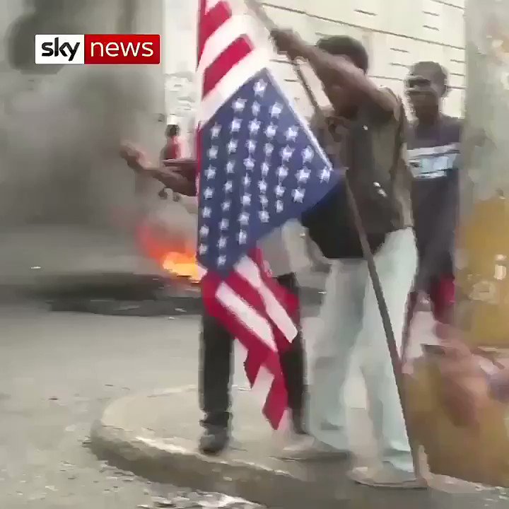 Anti-government protesters in #Haiti burn the 🇺🇸#US flag.