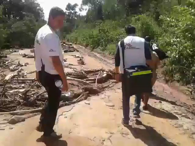Two #MSF outreach teams are currently working to access remote parts of #Chimanimani. Some roads have been completely washed away. Here one team decides to proceed on foot for 12km after throwing the medical kit across the river, with essential supplies for outreach