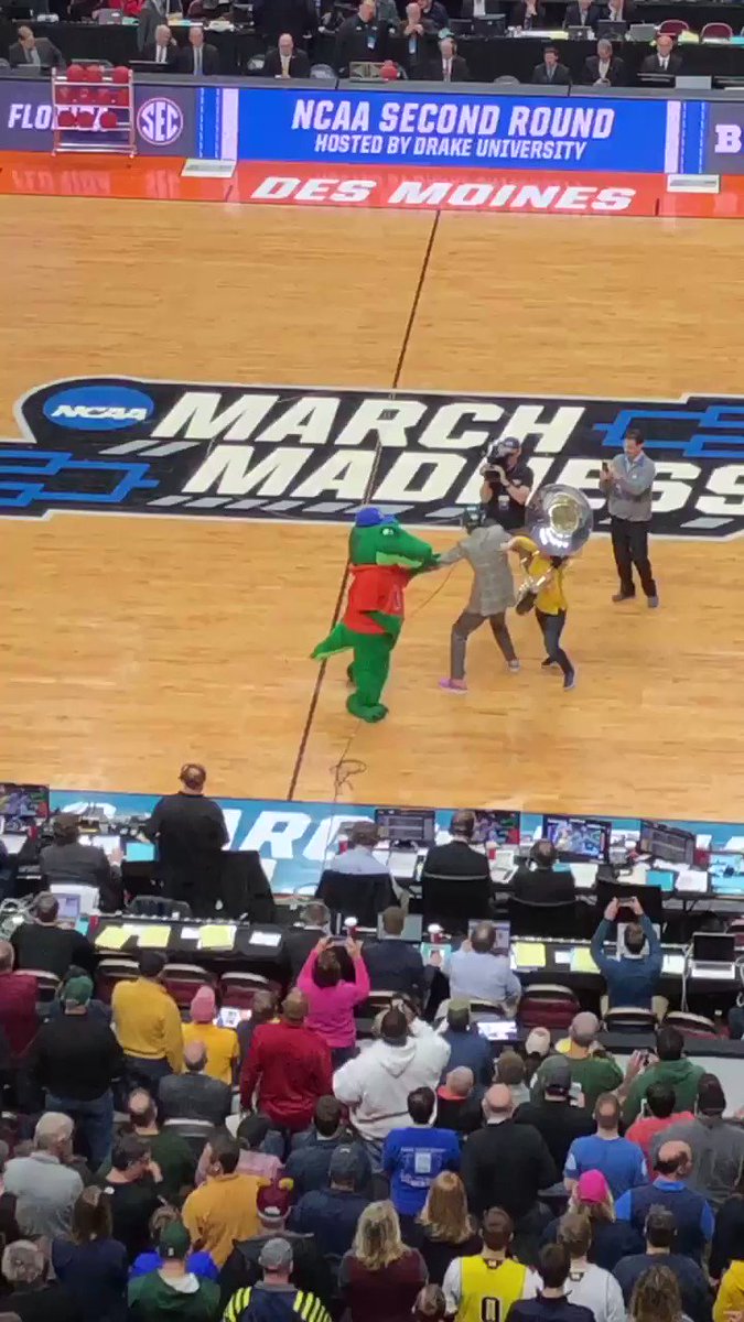 If you’re asking yourself “Is that Reggie Miller keeping the peace between the Florida mascot Albert and a Michigan tuba player?” The answer is yes. (Credit the tuba player with a solo tackle)