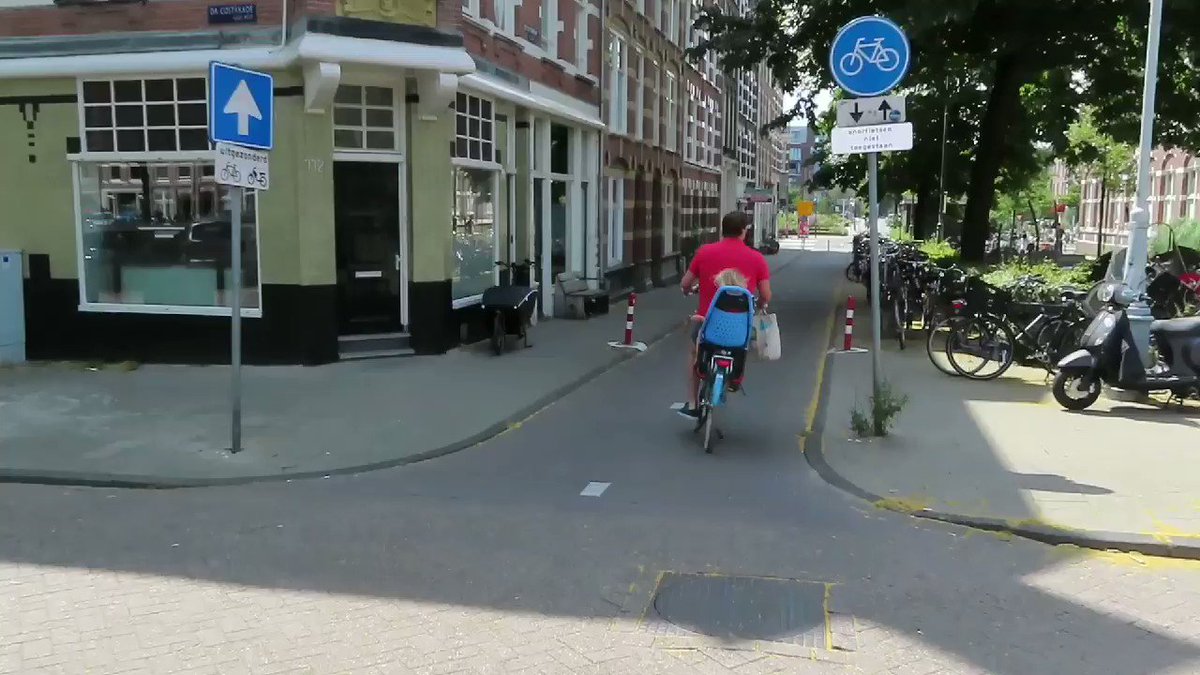 This street in Amsterdam used to be open to cars and have car parking on it. Now it is a cycle only street, with more bike parking and a larger children's playground
