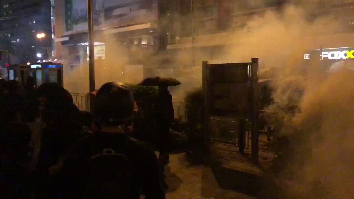 Protester front line advances through clouds of tear gas towards police