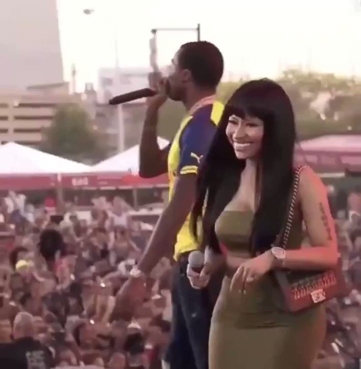 reaction encyclopedia on X: Pointless fancam of Nicki Minaj while on a  stage with her purse and a man in a yellow shirt behind her.   / X