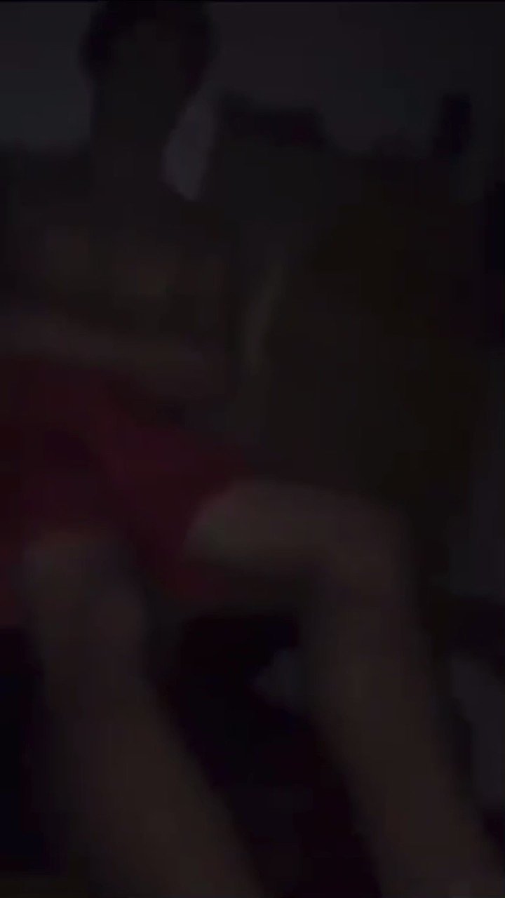 A shirtless man looks down with a surprised expression