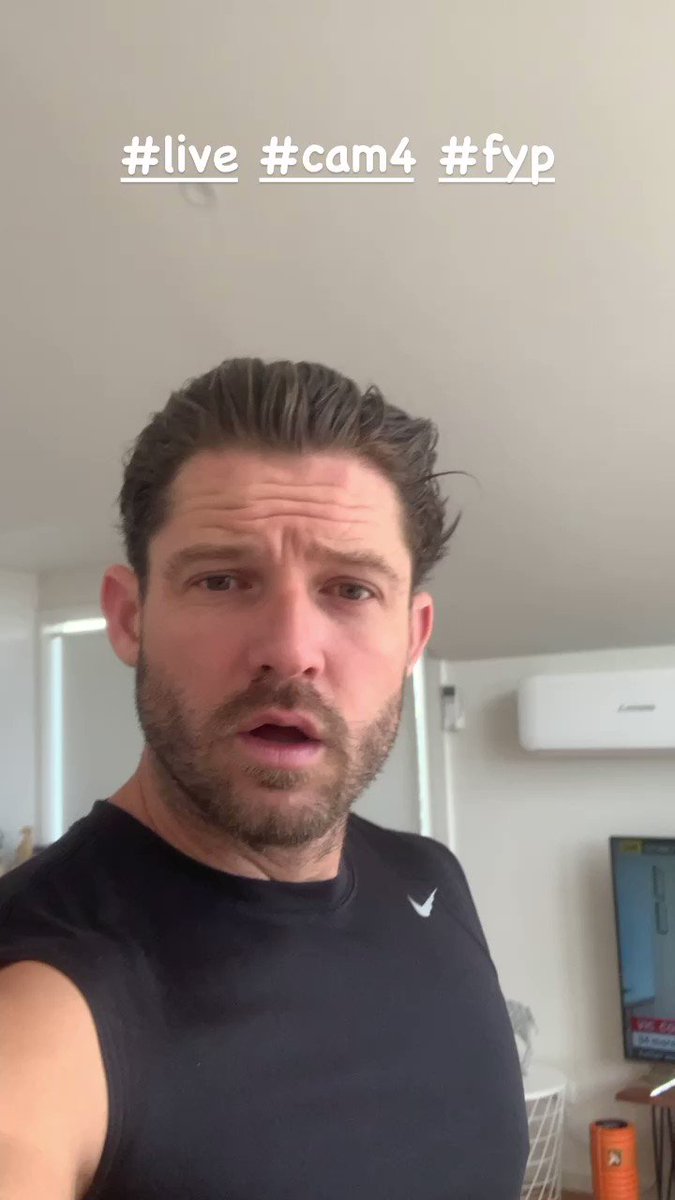 A video still of a man with a beard looking intently at the camera