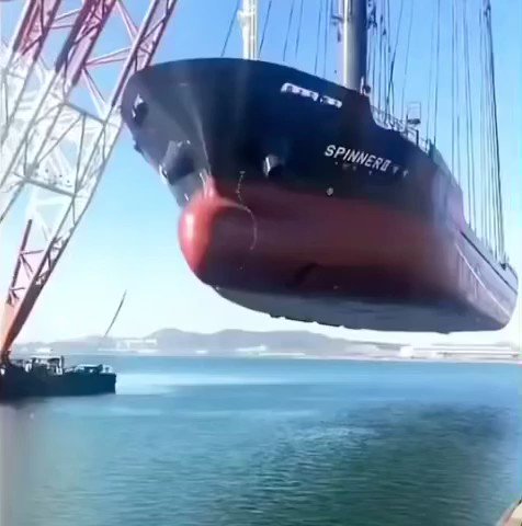The world's largest floating crane Hyundai 10000 carrying a giant ship.
