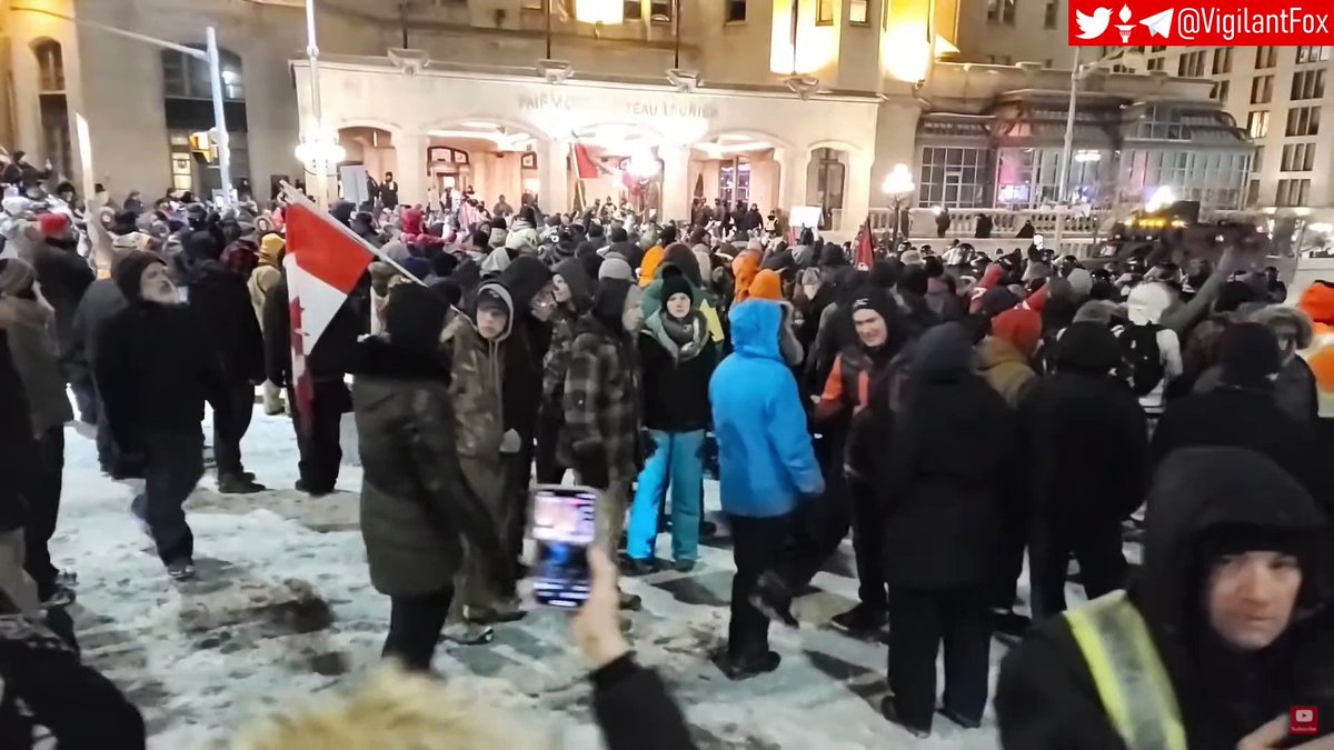 Ottowa Protestors Kneel In Prayer As They Hold The Line In Front Of Advancing Ottowa Police KaGWNtyraRSJ6baI