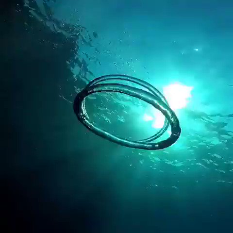 Premium Photo | Bubble ring ascends towards the sun, underwater