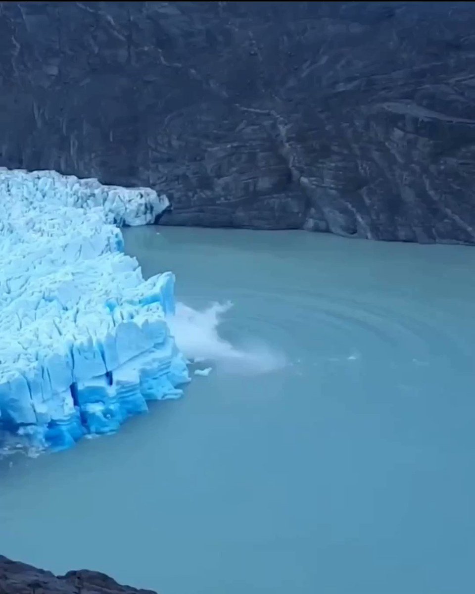 Grey glacier is in Southern Patagonia, Chile, here an enormous chunk breaks off

the underbelly appears dark blue as it is pressured by the sea to squeeze out air bubbles that scatter white light, bubble free ice reflects blue light

📹Laura Q. /LS