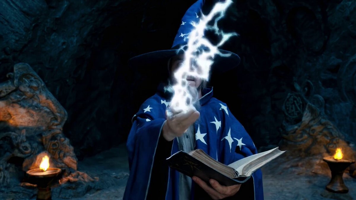 a wizard wearing a pointed hat and a blue robe with white stars casting a spell that shoots lightning from his hand and holding an old tome in his other hand