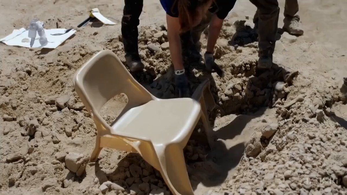 Archeologists discover a generic plastic chair in the desert, excavating and dusting it with great care.
