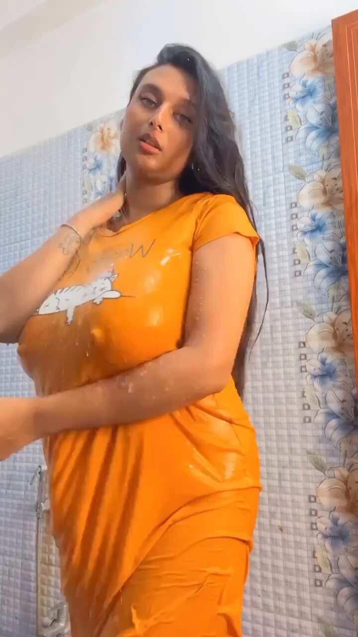 A woman in revealing attire striking a pose for a private photo shoot