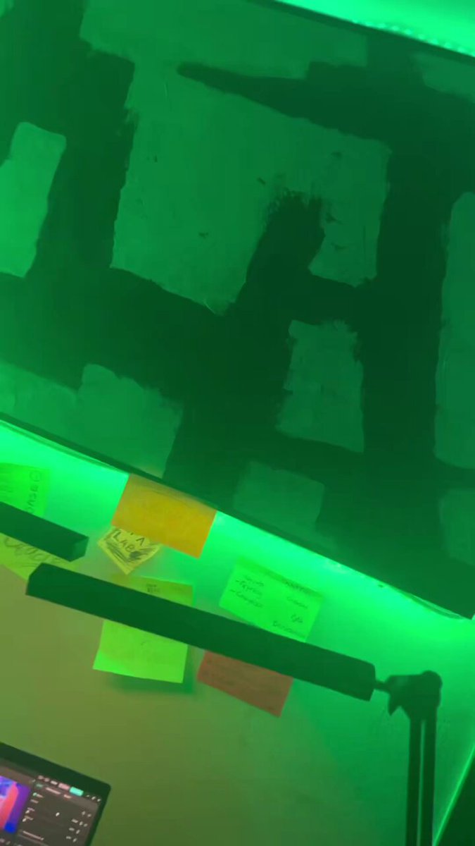 Green-lit workspace with sticky notes and a laptop, symbolizing the innovative environment of ENB x Onchain Summer Lagos