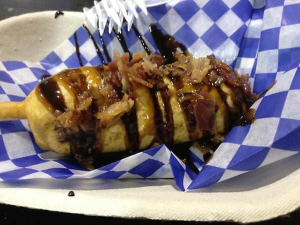 Deep fried bacon-wrapped Mars bar drizzled with chocolate and caramel sauce with bacon bits #CNEfood