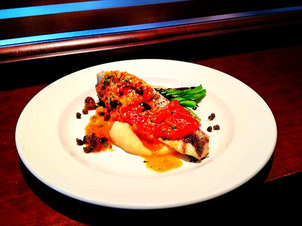 Bronzini with oven dried tomatoes, nicoise olives, parsnip purée and fried capers
