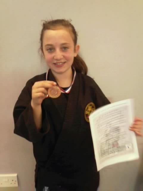 13Rake's tweet photo. My little champ and her first medal!! She's wicked!! http://t.co/rB3Mxn5r