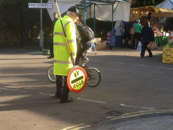 The lovely lollipop man who warms up everyone's day w a cheery greeting. East Street market, South London.