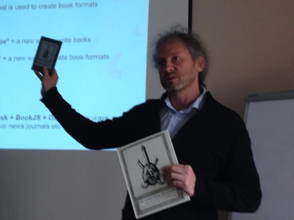 datatheism's tweet image. Adam Hyde holds up the latest books created with Booktype and BookJS in the browser. #Sourcecamp