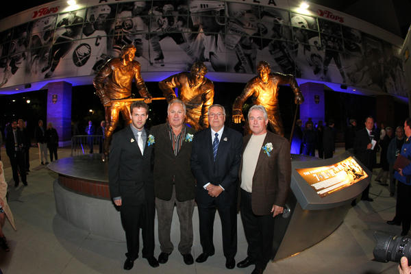 Cory Martin, Gilbert Perreault, Terry Pegula &amp; Rene Robert stand in front of the French Connection Statue! #AlumniPlaza