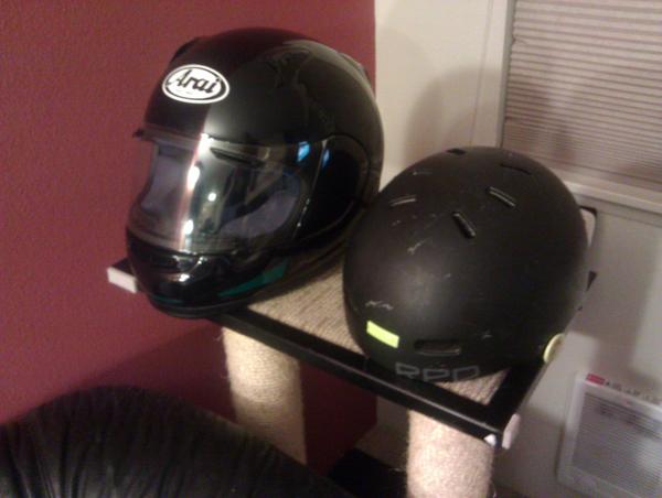 Bicycle helmet and motorcycle helmet on a cat tree