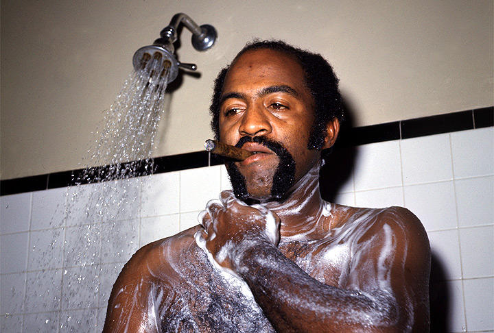 SI Vault on X: Luis Tiant smokes a cigar in the shower following