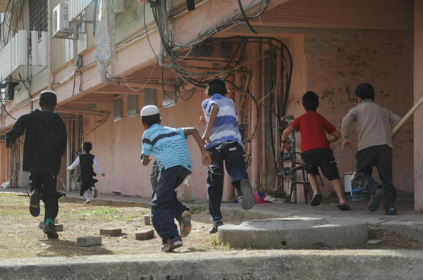 IDF's tweet photo. PHOTO: Kids running to shelter during a siren in Kiryat Malachi, where 3 civilians were killed by a rocket yesterday http://t.co/OHAXD6sM
