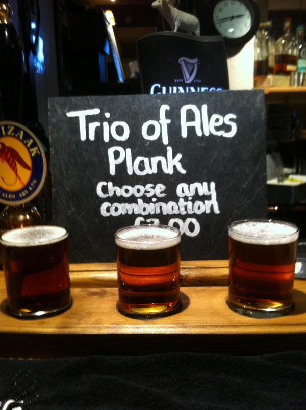 <a href="/VisitYourLocal/">Visit Your Local</a> have a look at our new #realale plank a sampler of local ales what you think?
