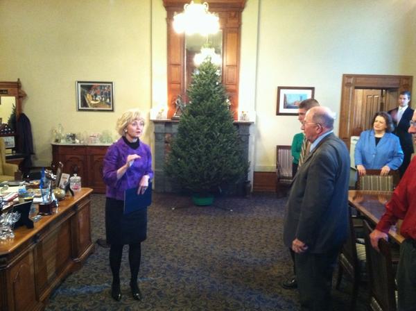 Receiving the annual Christmas tree in my office from Hensler Nursery.
