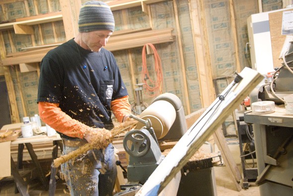 chdevelopments's tweet image. Randy begins work on the lathe. The project? A custom-milled mahogany finial for a staircase.