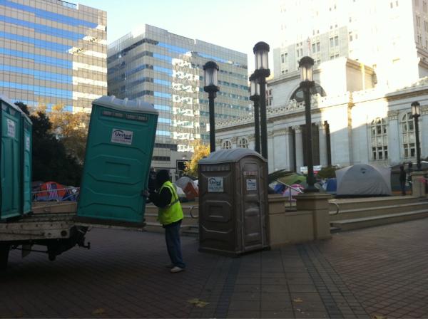 donuteer's tweet photo. Honeybuckets getting dropped at #OccupyOakland right now. NOT paid for by city, paid by donations #recall #OWS http://t.co/ZIKmBm07