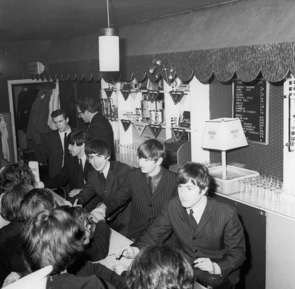 The fans got to meet the band - John, Paul, George and Ringo stood behind the bar and signed autographs after the gig