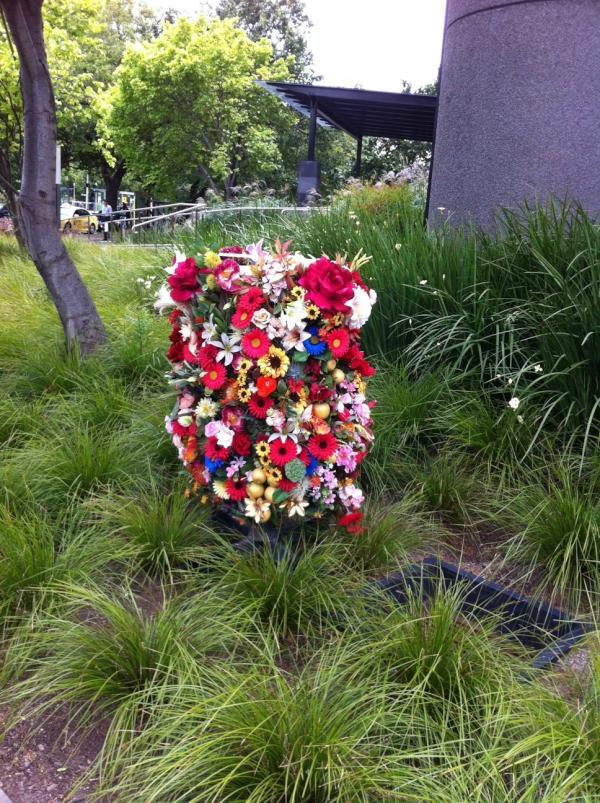 AllenNaughtin's tweet photo. Stumbled across a guerilla flower installation in the lanscaping work we did for 517 St Kilda Road. #LooksLikeAShrine http://t.co/GL6vRhH7