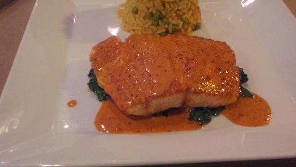 Salmon on a bed of Spinach with Mexican Rice and Guajillo Sauce